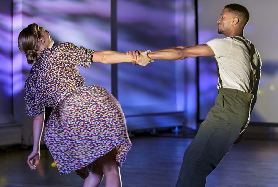 A woman and a man dance together
