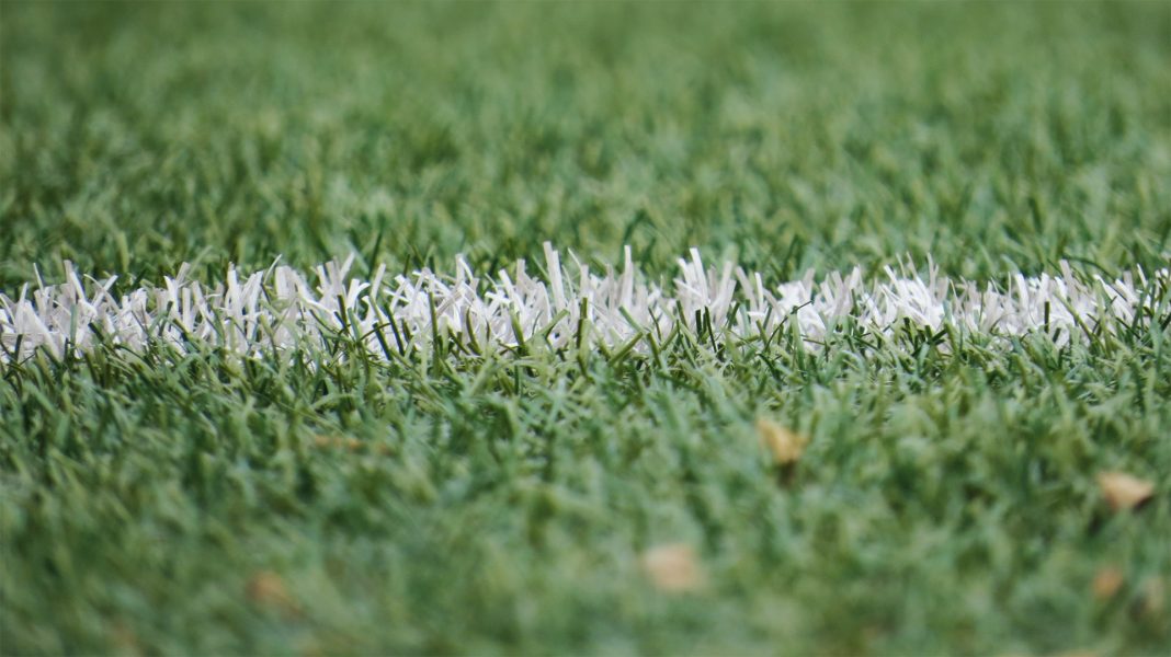 A closeup of white line on a football pitch