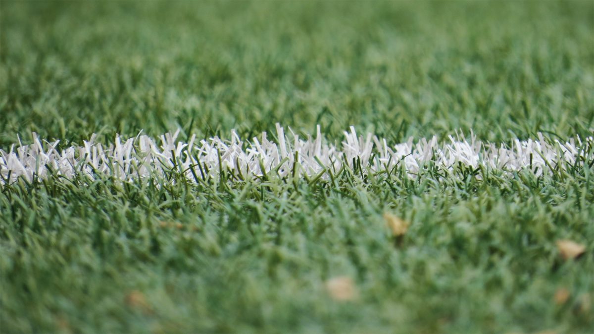 A closeup of white line on a football pitch
