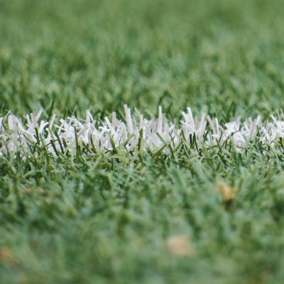 A closeup of white line on a football pitch