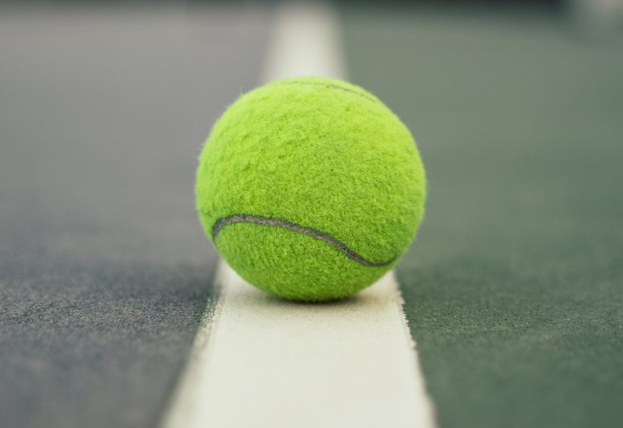 Tennis ball on a tennis court line
