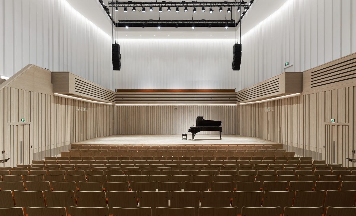 An empty theatre with a piano on stage