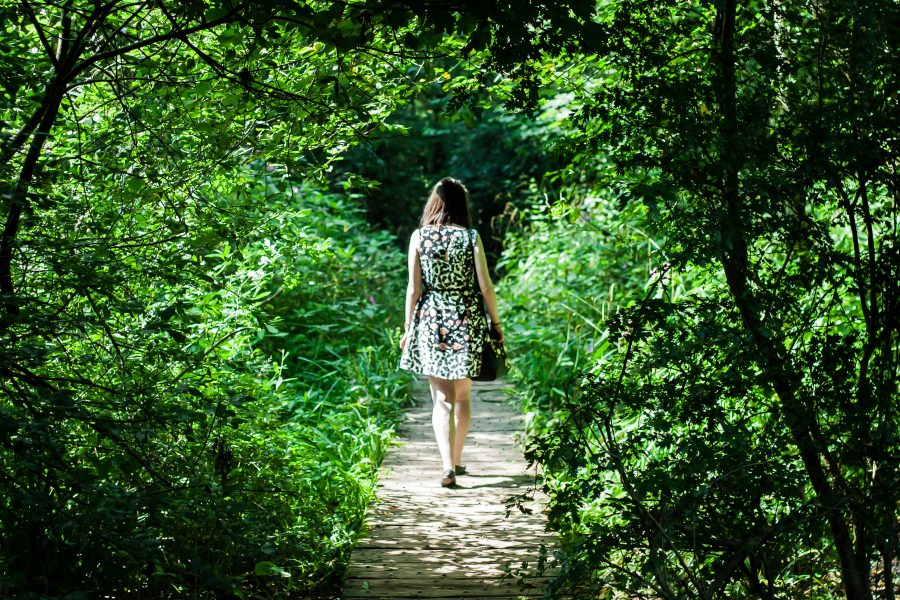 A woman walking in Fletcher Moss Botanical Garden