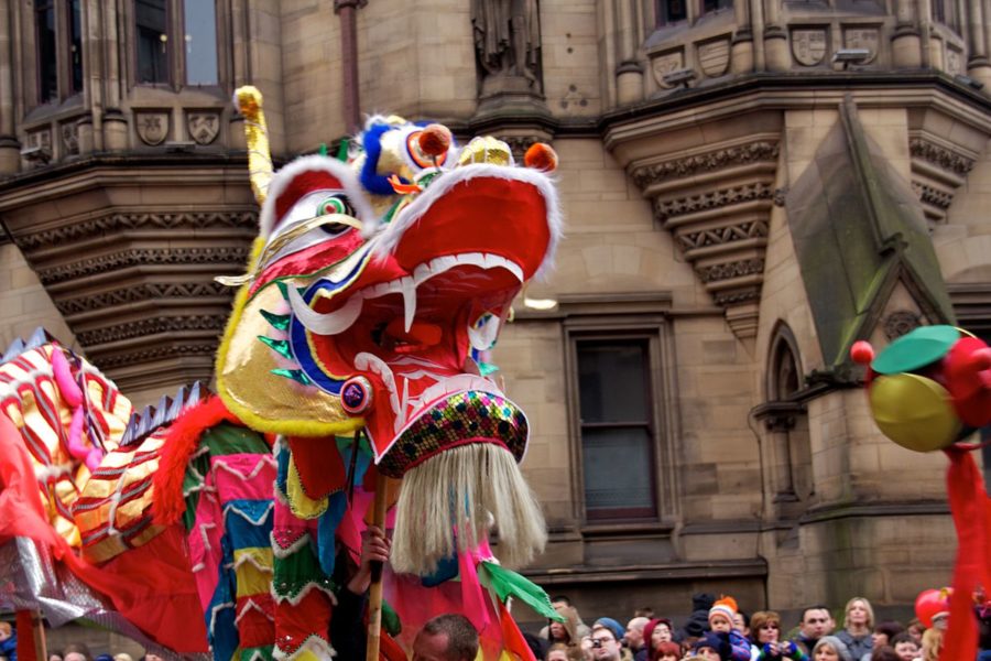 Chinese dragon puppet walks in front of crowd