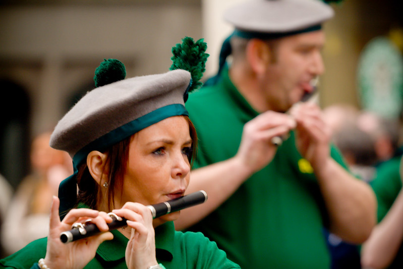 A lady plays an Irish flute in the Manchester Irish Parade.