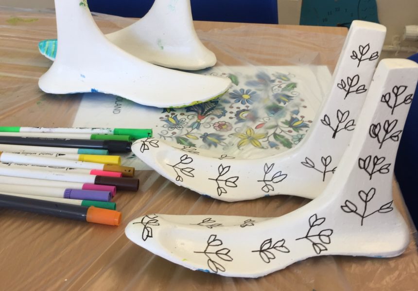 A decorated pair of plaster cast feet created at the Identity Feet workshop.
