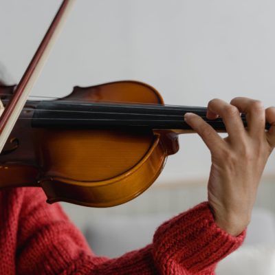 A young person plays a violin.