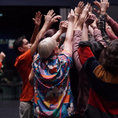 People crowd together at a creative workshop.