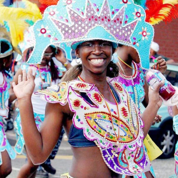 A dancer smiling in a carnival parade.