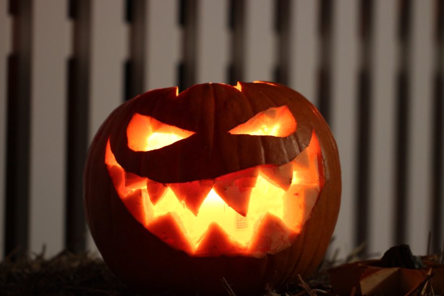 A glowing pumpkin with a face carved into it.