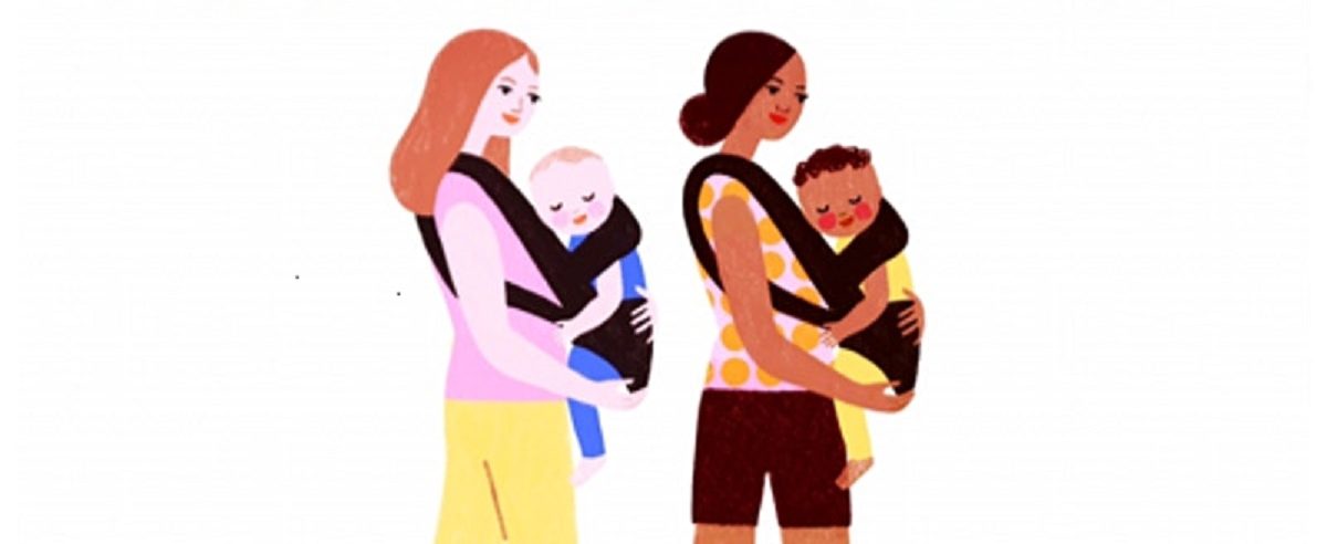 Two mums walk along with their babies in baby carrier strapped to the front of their bodies.