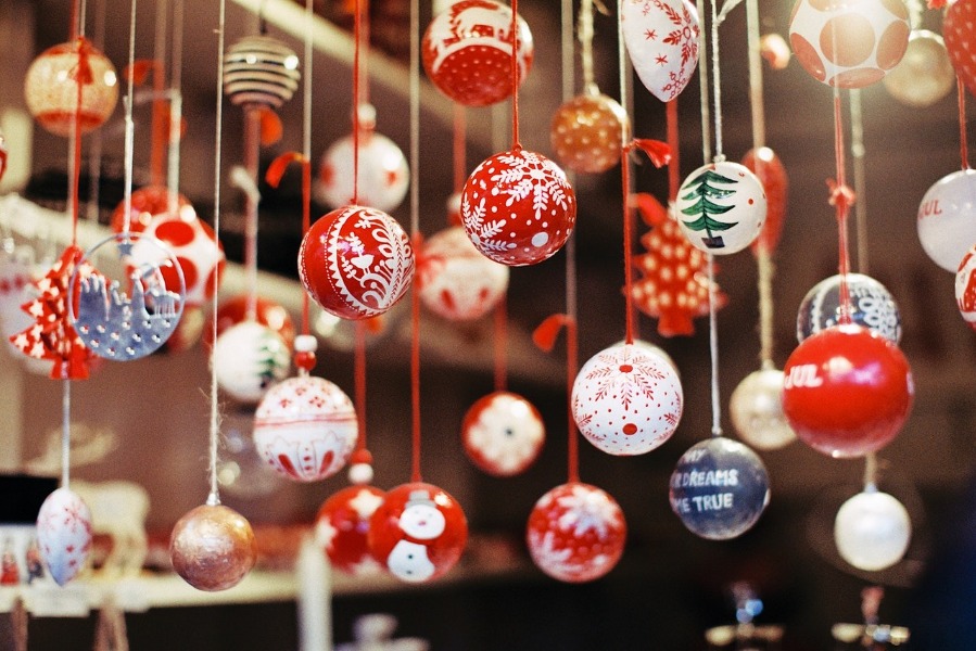 An assortment of Christmas baubles hang from above.