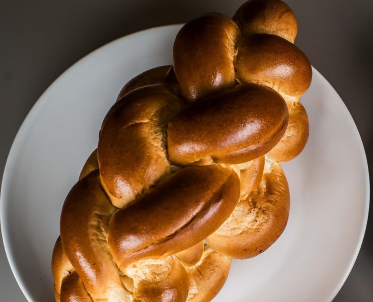 Challah bread on a white plate