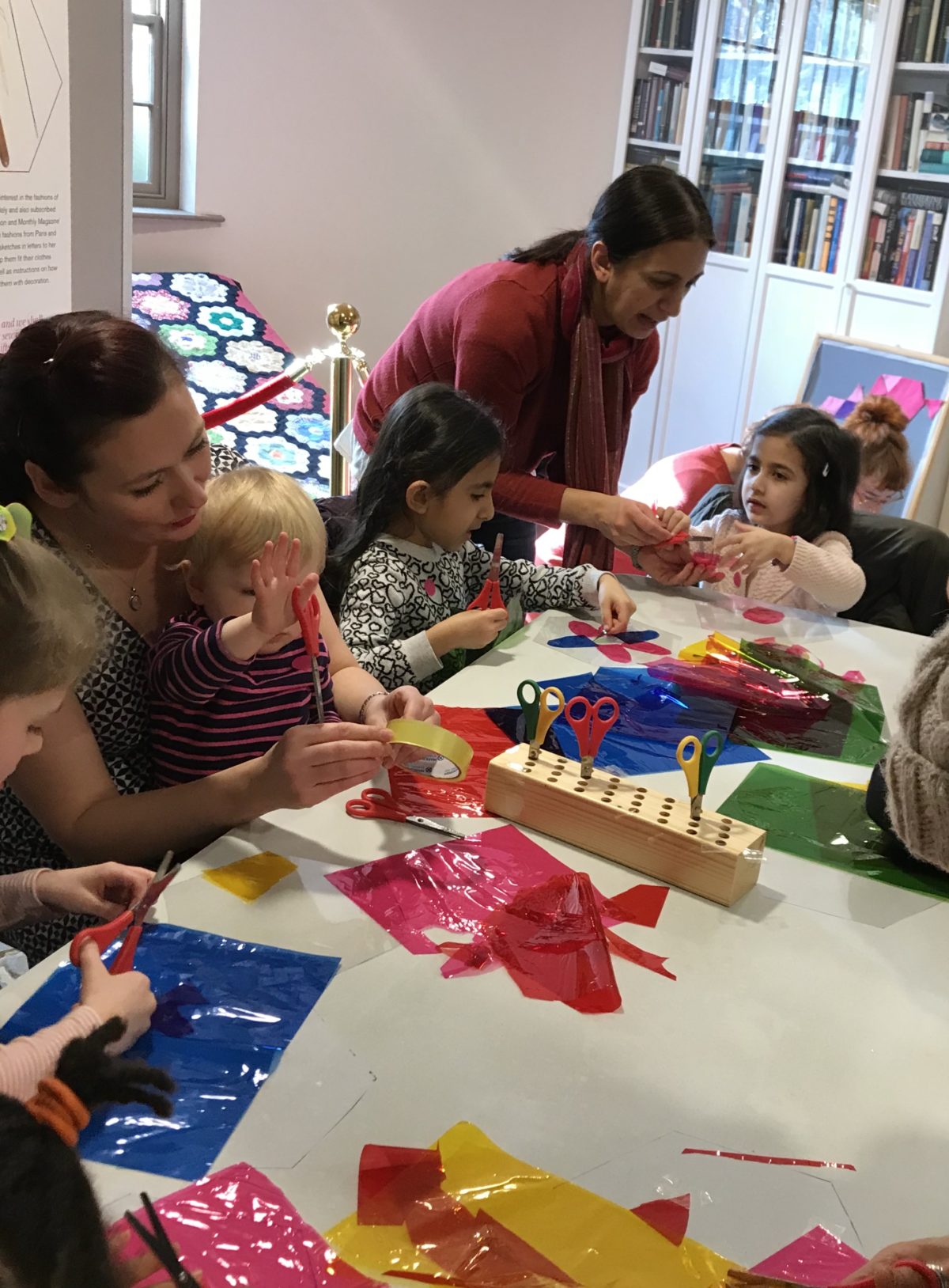 A group of children and their grown-ups doing a craft activity.