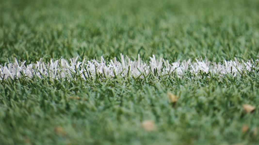 A white line on a grassy sports field