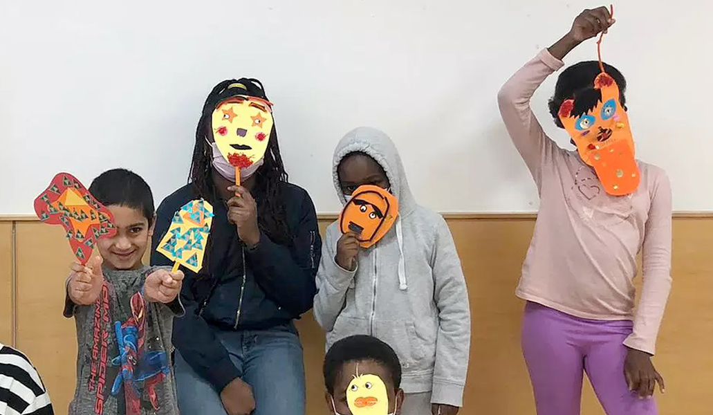 Young people enjoy a mask-making activity session