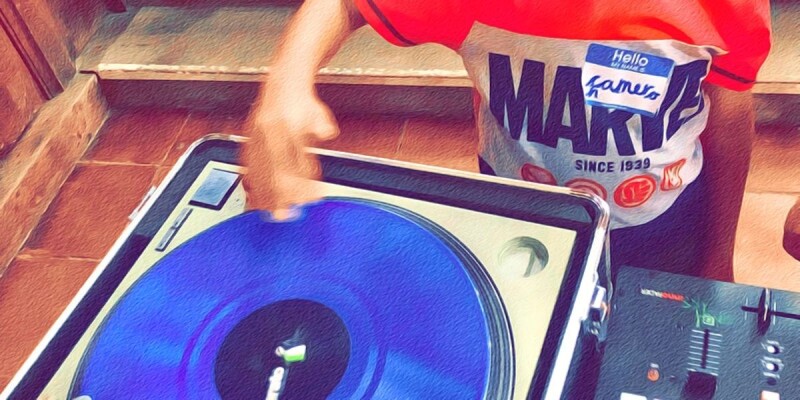 A young person spinning a record on a turntable