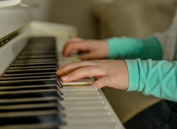 A young person's hands playing the piano