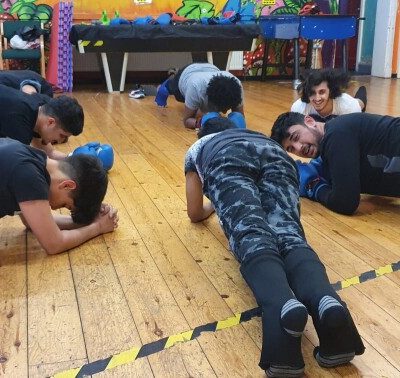 A group of young people planking