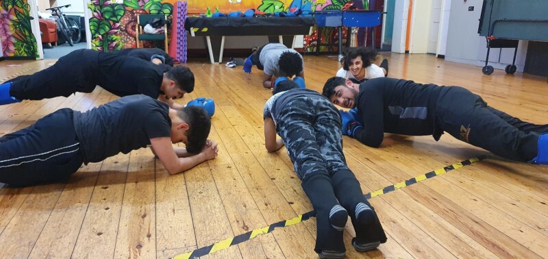 A group of young people planking