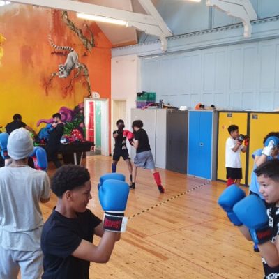 A group of young people enjoying a Thai boxing class