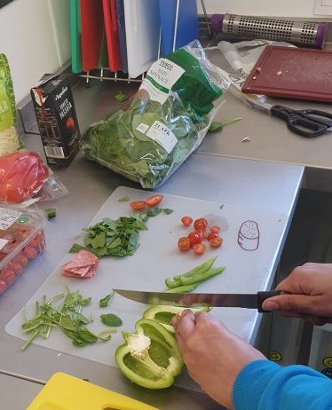 A person prepares a salad