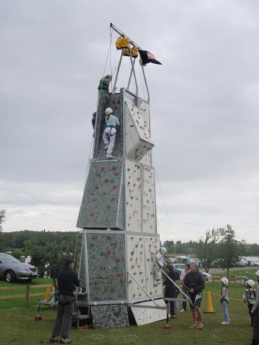 Climbers scale their way up a mobile climbing wall
